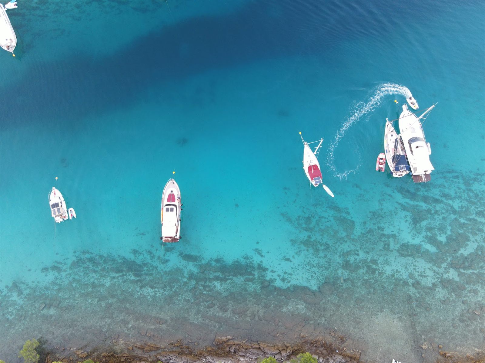 Aerial view of turquoise Adriatic water with anchored boats in Zadar, Croatia